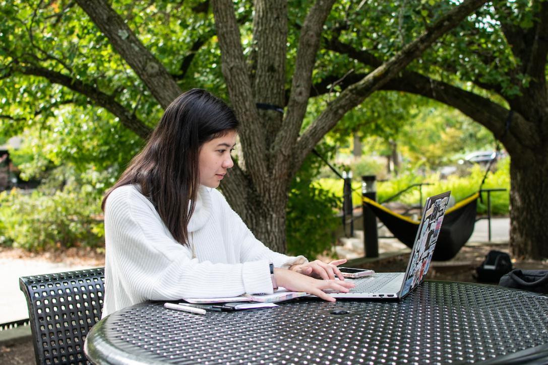 Student typing on a laptop.